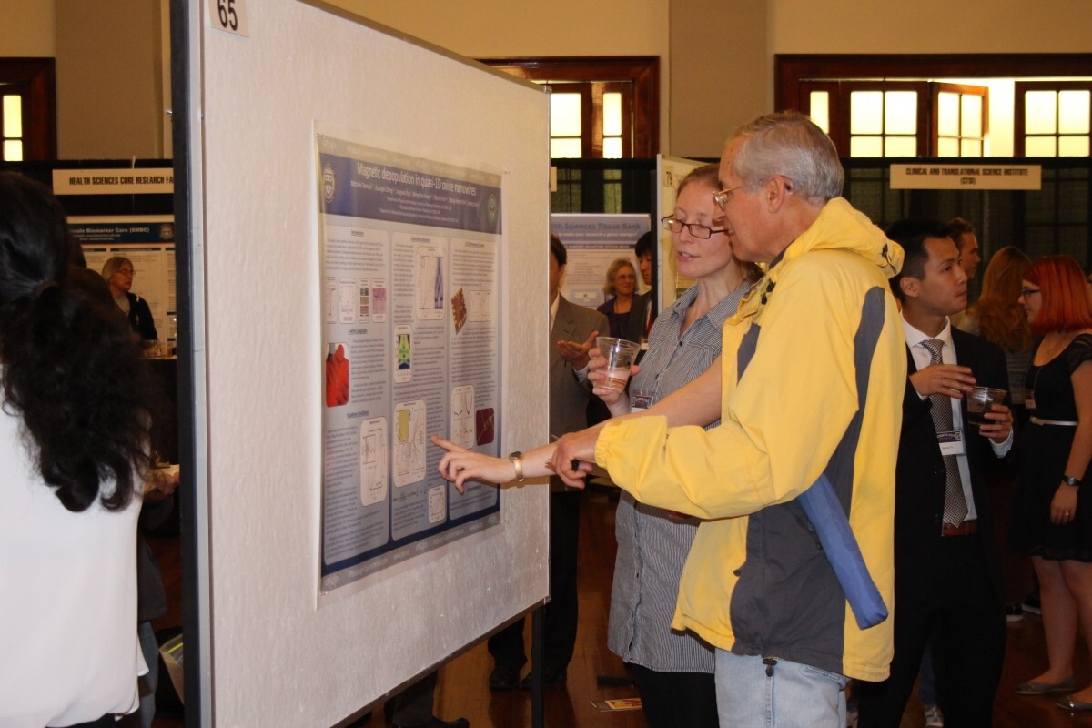 Two people looking at a poster