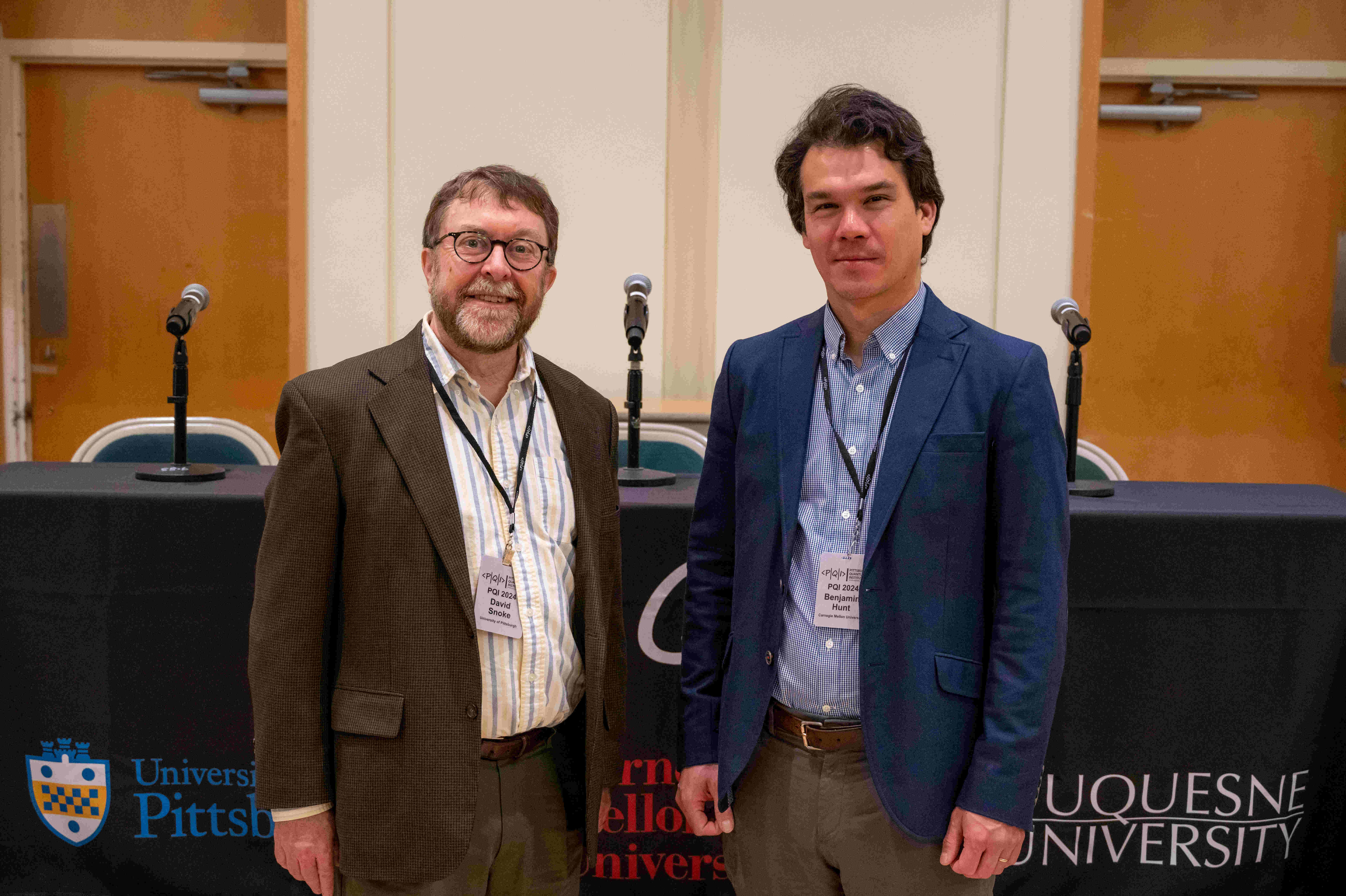 PQI Co-Directors standing next to each other at conference.
