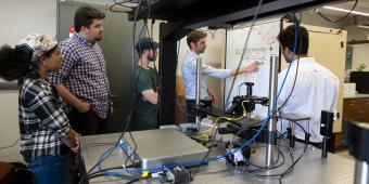 Dr. Nathan Youngblood works with students in the lab. 